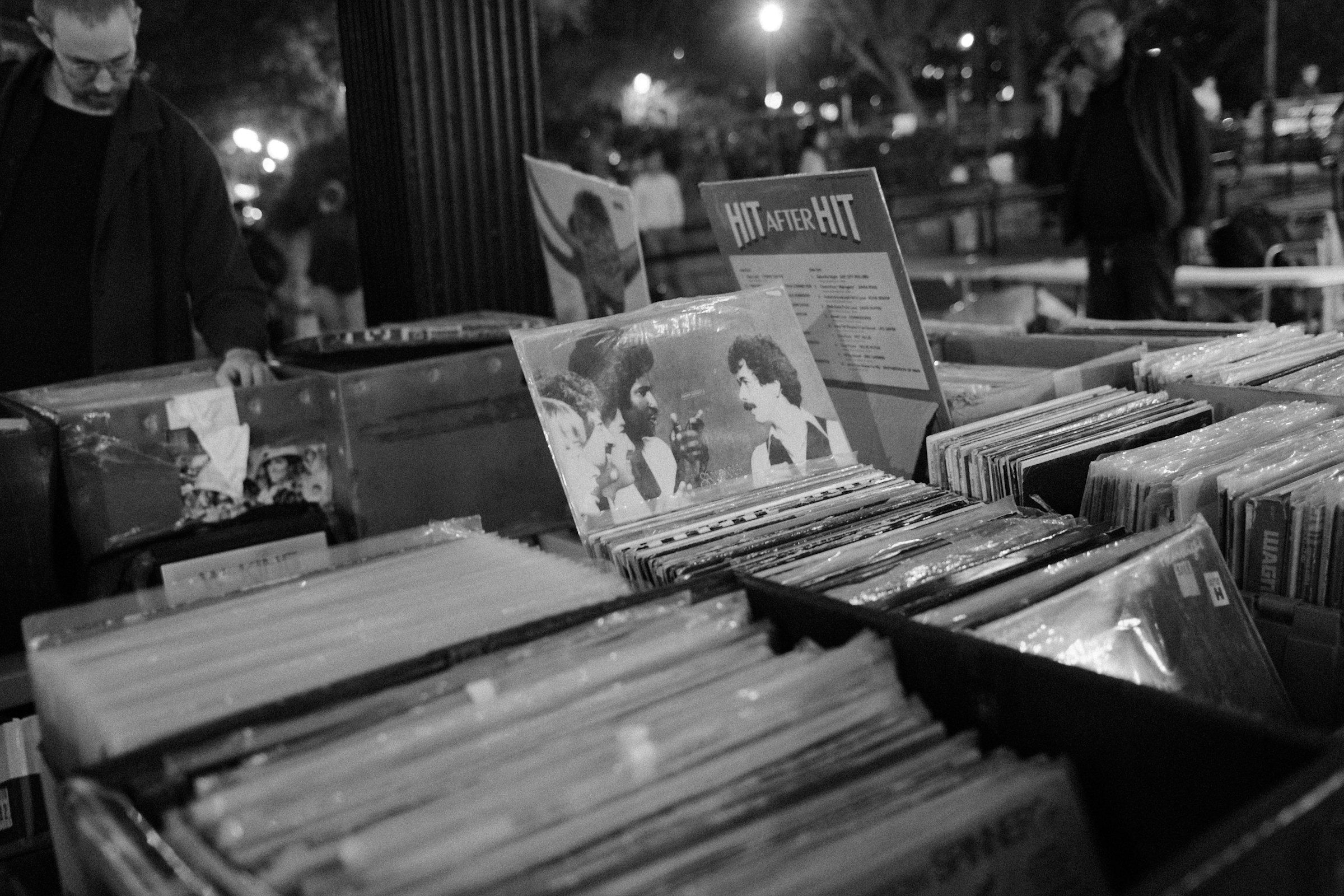Rows of vinyl records standing upright in a browsing crate, photographed from a slightly elevated angle