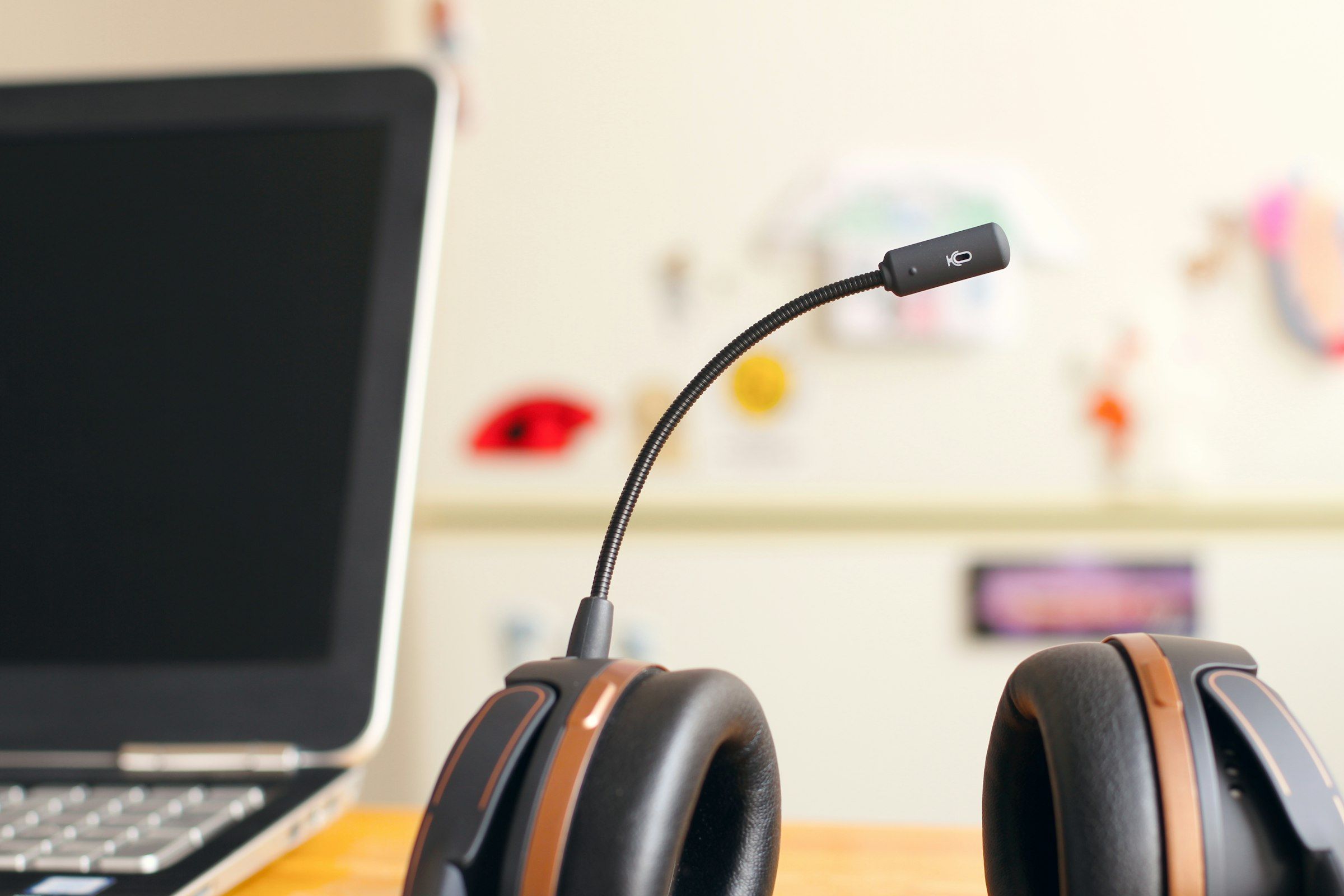 A call-centre headset resting beside a laptop on a desk, with no one at the workstation