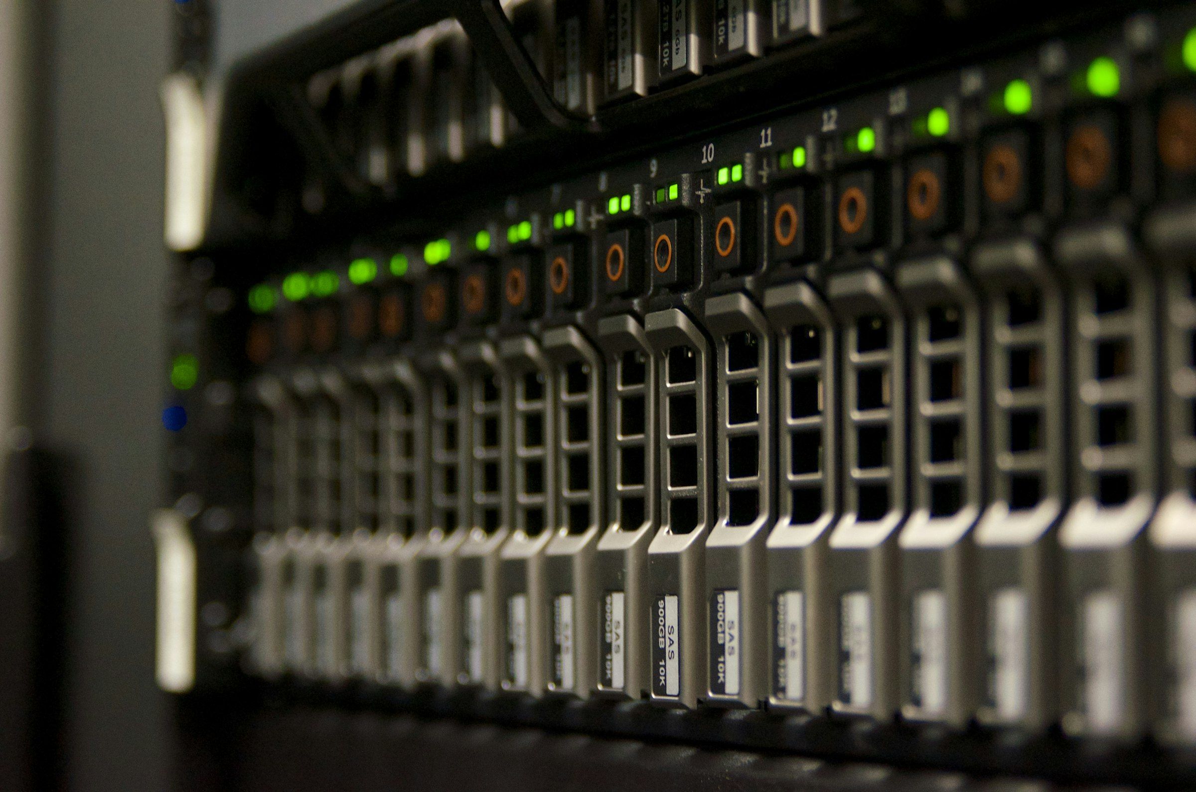 A server rack in a darkened data centre, its front panel lit by rows of green and purple indicator lights