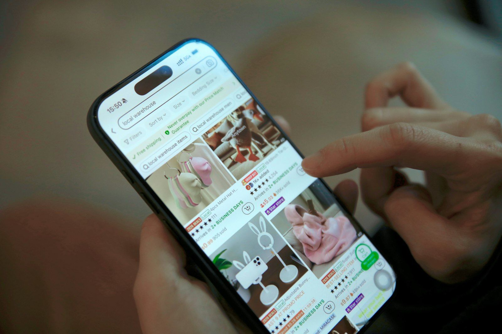 A person browsing a grid of products in a shopping app on a smartphone