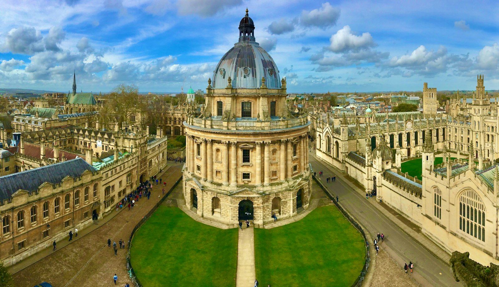 The domed Radcliffe Camera library among the stone college buildings of the University of Oxford, seen from above